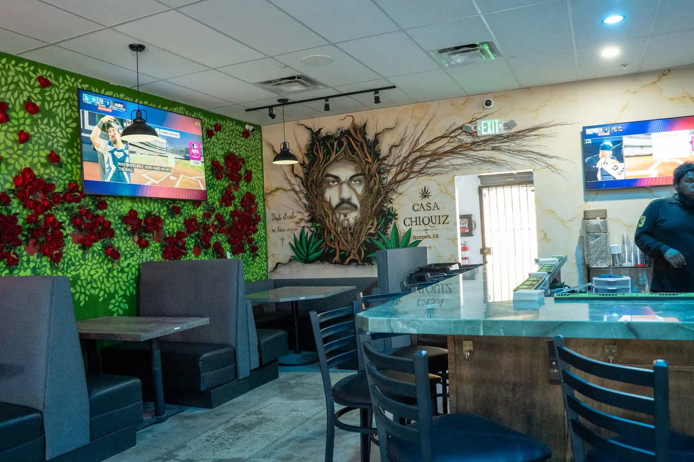 Booths and green marble bar beside the Casa Chiquiz agave mural